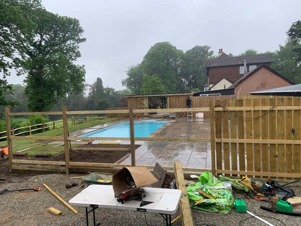 This is a photo of Bespoke custom fencing installed around a swimming pool by Fast Fix Fencing Sevenoaks