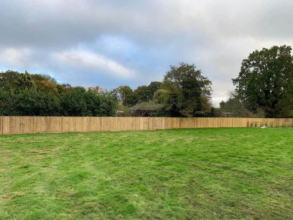 This is a photo of feather edge fencing installed around the edge of a field by Fast Fix Fencing Sevenoaks